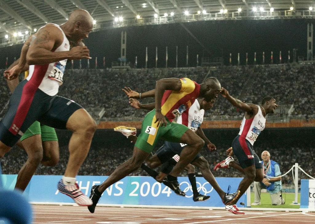 22/8/2004: Francis Obikwelu corta a meta do estádio olímpico de Atenas na segunda posição, conquistando a medalha de prata nos 100 metros (Reuters/Ruben Sprich)