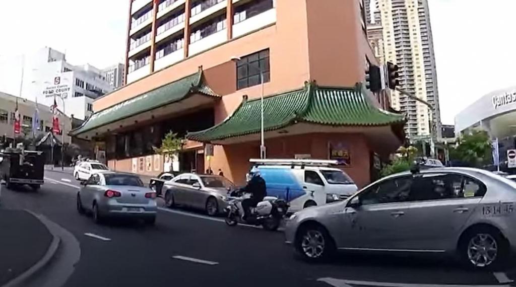 Condutora passa à frente de táxi e polícia (captura YouTube)