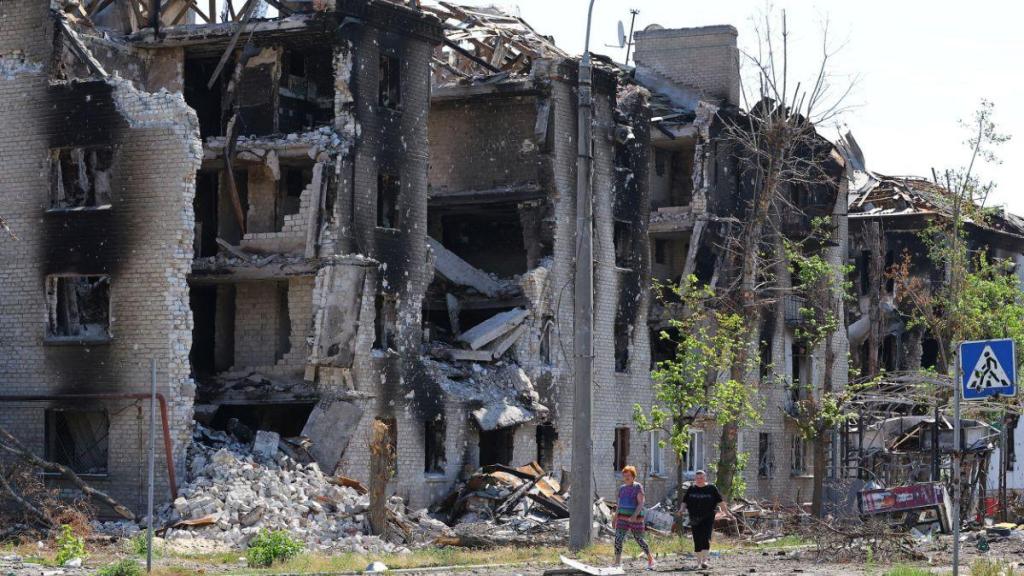 Moradores passam por prédios de apartamentos destruídos na cidade de Severodonetsk, na região de Lugansk, na Ucrânia, na quinta-feira, 30 de junho (CNN)