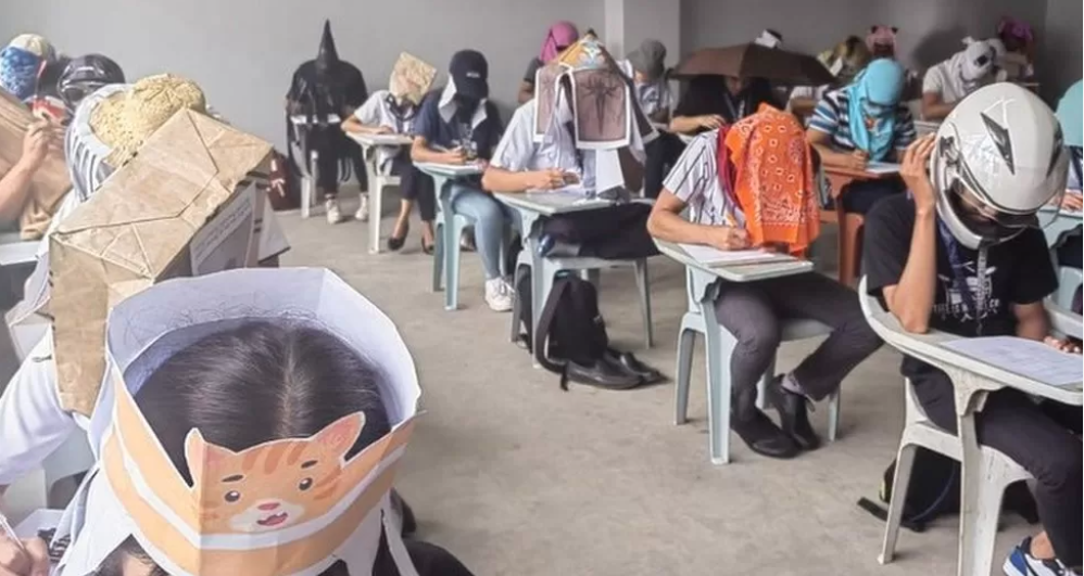 Estudantes de universidade nas Filipinas usam "chapéus anti-cábulas" originais