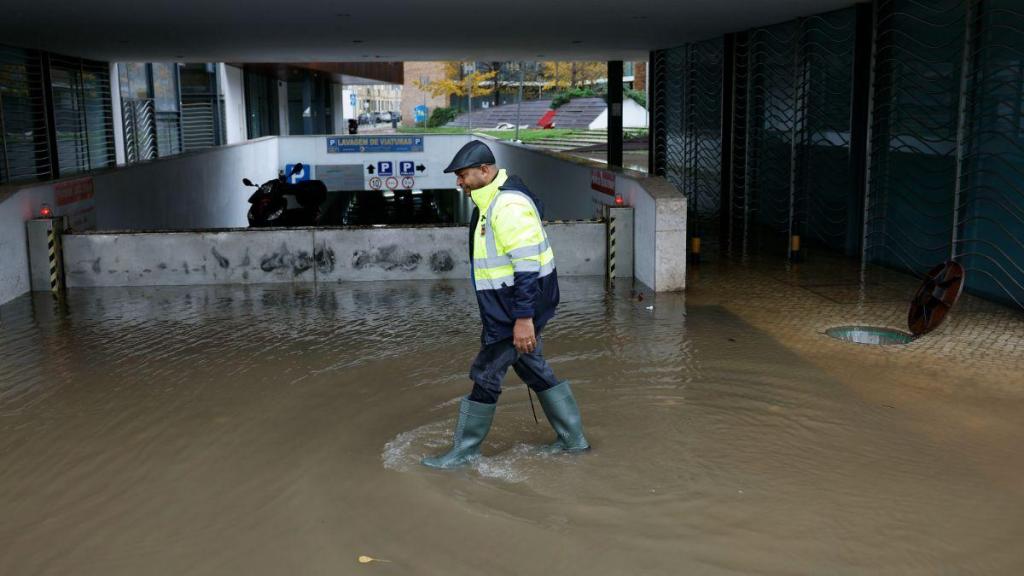 Trabalhadores municipais limpam uma rua inundada em Alcântara. (António Pedro Santos/Lusa)