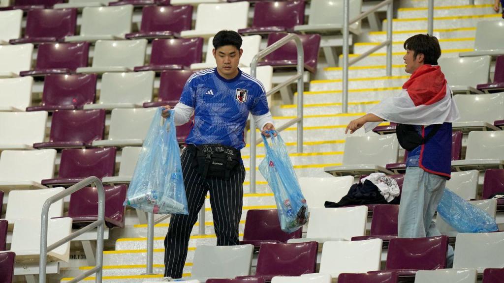 Adeptos do Japão recolhem lixo após jogo no Mundial 2022 (AP Photo/Eugene Hoshiko)