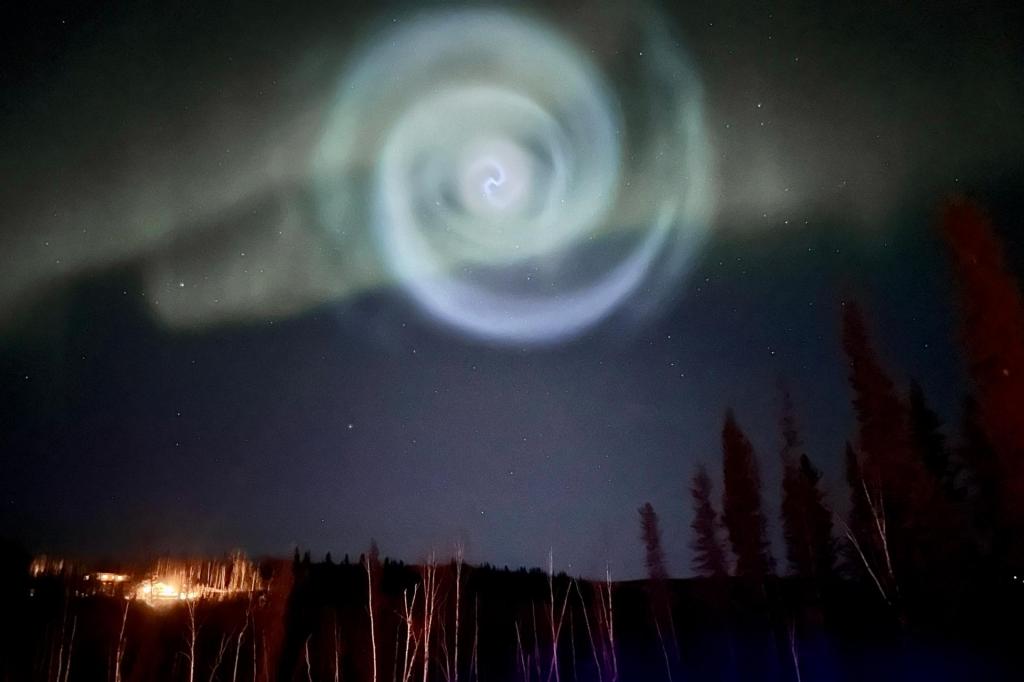 Estranha espiral azul clara surgiu entre a aurora boreal no céu noturno do Alasca (Associated Press)